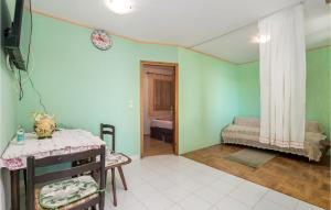 a room with green walls and a bedroom with a bed at Stunning Apartment In Senj With Kitchen in Starigrad