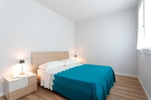 a bedroom with a blue and white bed and a table at Antica Pusterla Maison de Charme in Vicenza