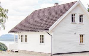 a white house with a black roof at Lovely Home In Fister With Wifi in Fister
