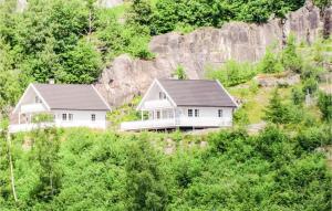two houses on a hill with trees at Lovely Home In Fister With Wifi in Fister