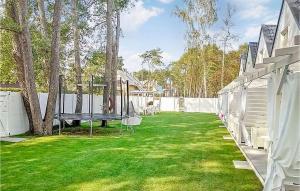 un patio trasero con una mesa de ping pong en el césped en Gorgeous Home In Miedzywodzie With Wifi, en Międzywodzie