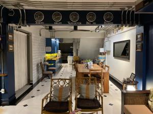 a dining room with a table and chairs at Bed in Town in Chiang Mai