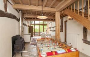 a living room with a foosball game on a table at La Maison D'albertine in Briscol