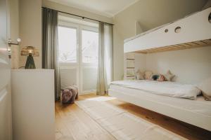 a bedroom with a bunk bed and a window at Nordsee Park Haus Stella in Dangast