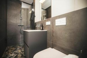 a bathroom with a toilet and a sink and a shower at Nordsee Park Haus Stella in Dangast +33 photos