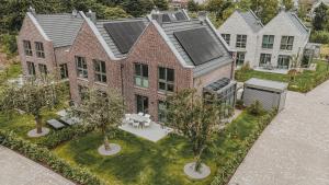 an aerial view of a house with trees in the yard at Nordsee Park Haus Stella in Dangast