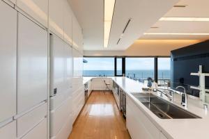 a large kitchen with a view of the ocean at Villa Orchid in Otaru