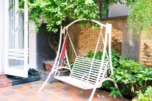 a white porch swing on the porch of a house at Rose's House Hue in Hue