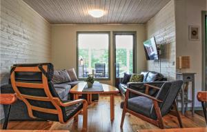 a living room with a couch and chairs and a table at Stunning Home In Figeholm With Kitchen in Figeholm