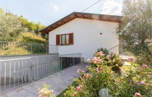 a white house with a balcony and flowers at Casa La Coccinella in Nestore +19 photos
