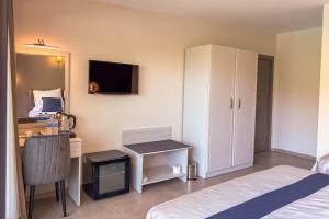 a bedroom with a desk and a bed and a computer at Aktaş Butik Hotel in Muğla