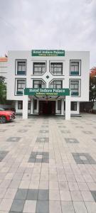 a building with a parking lot in front of it at Hotel Indore Palace - Newly Renovated Hotel in Shirdi