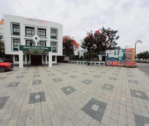 a large white building with a sign in front of it at Hotel Indore Palace - Newly Renovated Hotel in Shirdi