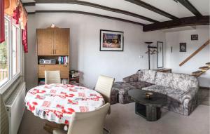 a living room with a table and a couch at Nice Home In Wasungen With Wifi in Wasungen