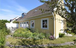 a small yellow house with a roof at Holiday Home Visby 49 in Visby