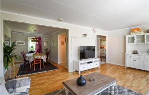 a living room with a table and a dining room at Holiday Home Visby 49 in Visby