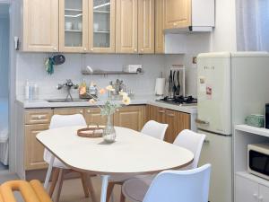 a kitchen with a white table and white appliances at Naksan Wellness Stay, Jongno, Quiet & Cozy in Seoul