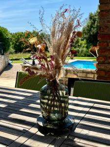 a vase with flowers in it sitting on a table at Villa Leopoldo by Istrian Country Houses in Barat