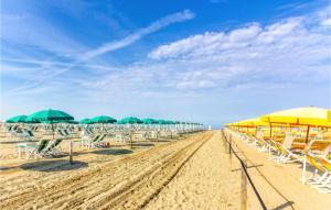 a beach with many chairs and umbrellas and tables at Casa Fulvia in Camaiore