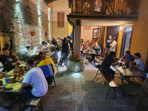 a group of people sitting at tables in a restaurant at San Rocco Affittacamere in San Severino Marche