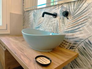 a bathroom with a bowl sink on a wooden counter at Villetta Romeo in Marina di Pietrasanta +39 photos
