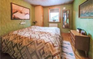 a bedroom with a bed and a dresser and a window at Lovely Home In Farhult With Kitchen in Farhult