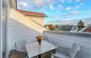 a vase of flowers on a table on a balcony at Baltischer Hof Apartment 65 in Boltenhagen +32 photos