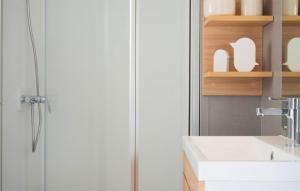 a bathroom with a sink and a shower at Awesome Stacaravan In Hoogersmilde in Hoogersmilde