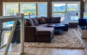 a living room with a couch and a table at Awesome Home In Vrådal With Lake View in Vradal