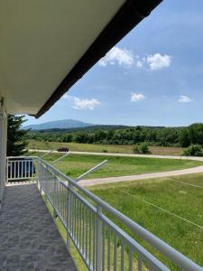a porch with a view of a field at Apartman Potok in Livno