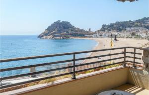 a balcony with a view of a beach and the ocean at Lovely Apartment In Tossa De Mar in Tossa de Mar