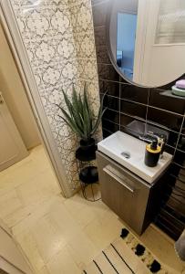 a bathroom with a sink and a mirror at 110 Sqm 2BR Edem beach luxury apartment in Athens +18 photos