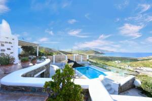 a swimming pool with a view of the ocean at Villa Irina Mykonos in Ftelia