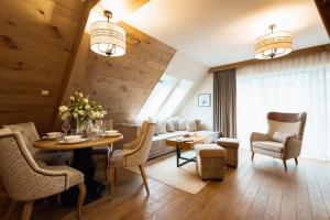 a living room with a table and chairs at Aparthotel Merynos in Zakopane