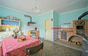 a kitchen with a table and a brick fireplace at Awesome Home In Prodin Dol in Ivančići