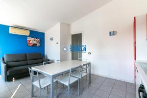 a living room with a table and a couch at Condominio Milan in Lido di Jesolo