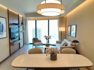a living room with a table and a couch at 2BD Luxury Opera District Apt Downtown in Dubai