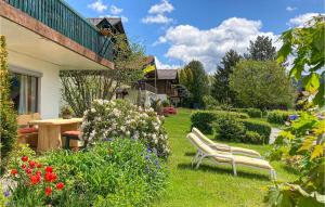 a garden with two chairs in the grass at Two-Bedroom Apartment In Arrach in Arrach
