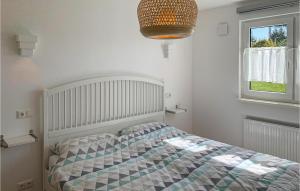 a white bedroom with a bed and a window at Stunning Apartment In Warin With Sauna in Warin