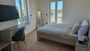Postel nebo postele na pokoji v ubytování Richi Rooms & App