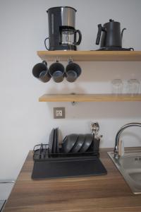 a kitchen shelf with pots and pans on it at Star Hotel in Rhodes Town