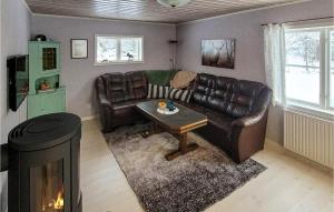 a living room with a leather couch and a table at Holiday Home Hålan Skepplanda in Hålan +10 photos