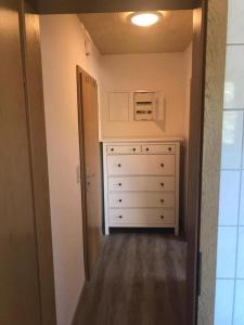 a room with a chest of drawers and a microwave at Fewo 71 Kleine 1 Raumwohnung in Roggow in Roggow