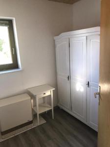 a room with a table and a white cabinet at Fewo 71 Kleine 1 Raumwohnung in Roggow in Roggow