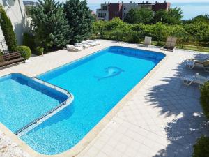 a swimming pool with a dolphin in the water at Milana-2 Sea View in Byala