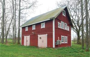a red barn sitting on top of a field at Three-Bedroom Holiday Home In Romakloster in Romakloster