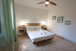 a bedroom with a bed and a ceiling fan at LVG Hotel Collection - Tornielli 9 in Novara