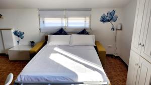 a bedroom with a large white bed with blue pillows at Rio Vivo Home in Termoli