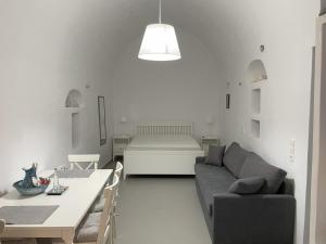 a living room with a couch and a table at Anafi Tholos House in Anafi