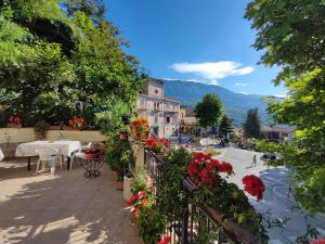 a view of a town with flowers on a balcony at Amoroso's house, affittacamere in Caramanico Terme